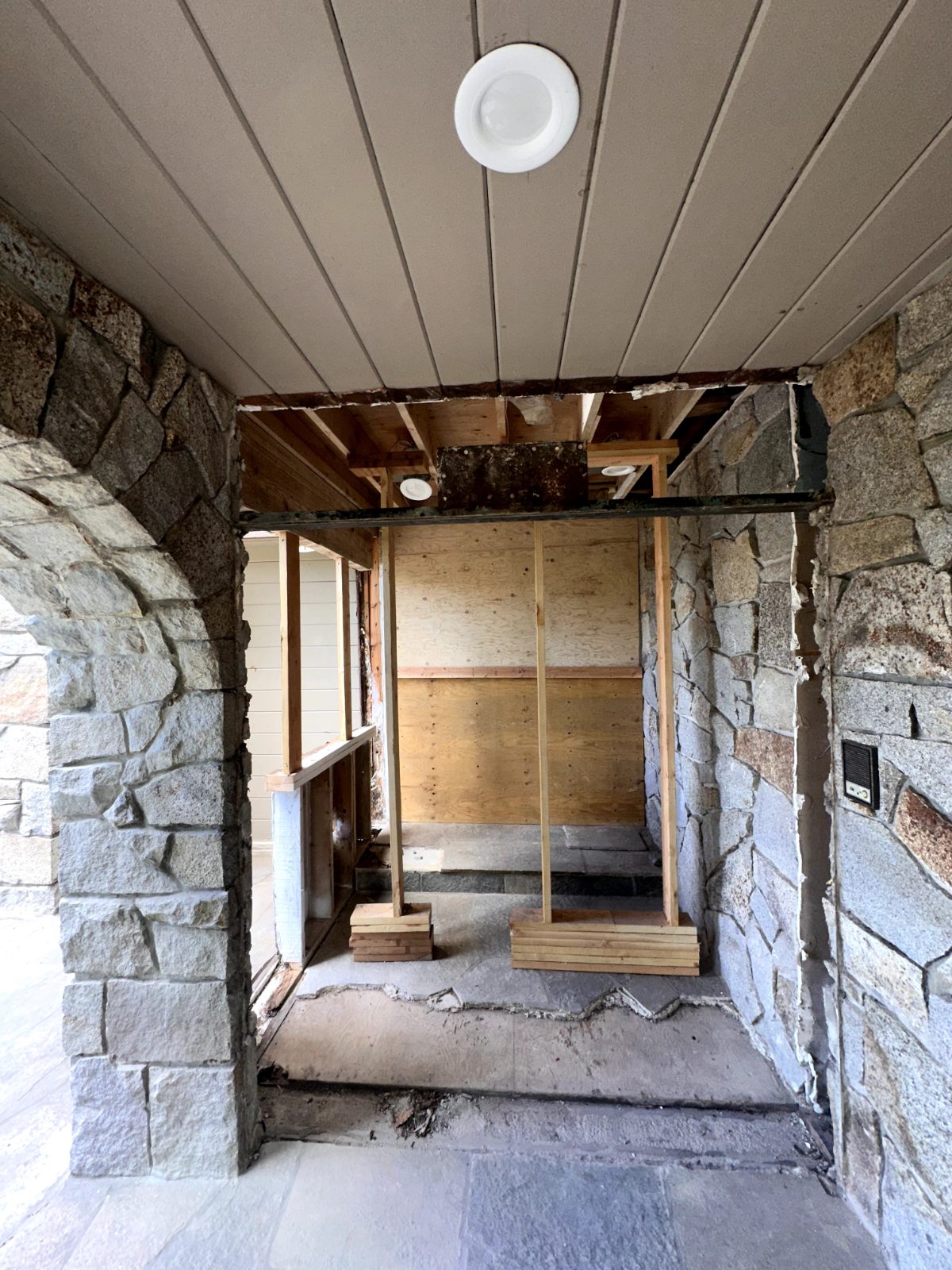 Stone archway with rotted framing removed during deck restoration