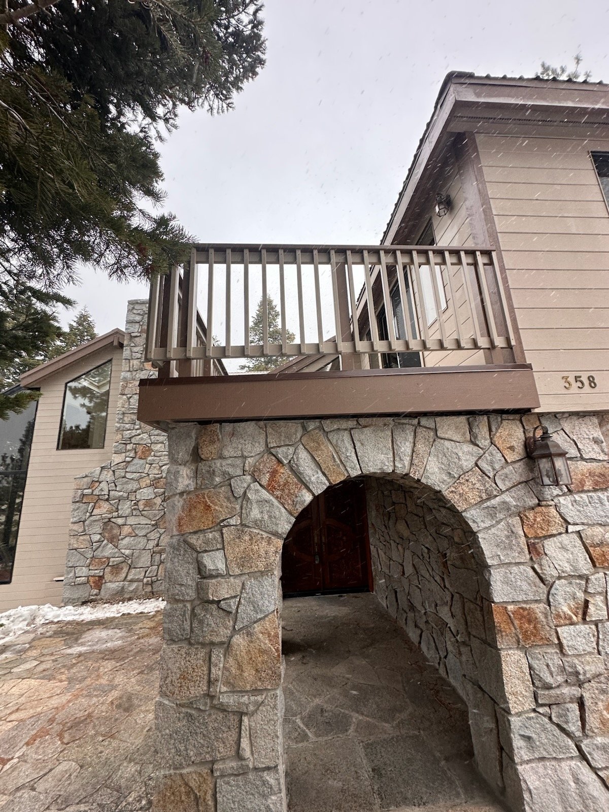 Rebuilt deck and railing above a stone arch after wood rot repair, Lake Tahoe