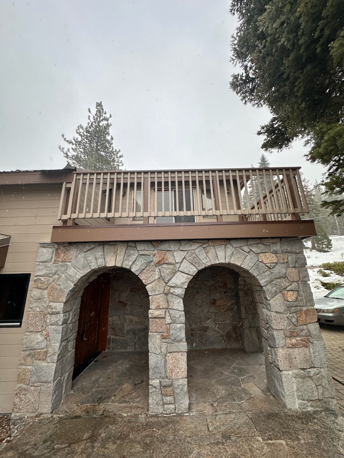 Restored deck with new railing over two stone arches after wood rot repair, Lake Tahoe